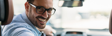 Portrait of a handsome businessman driving car